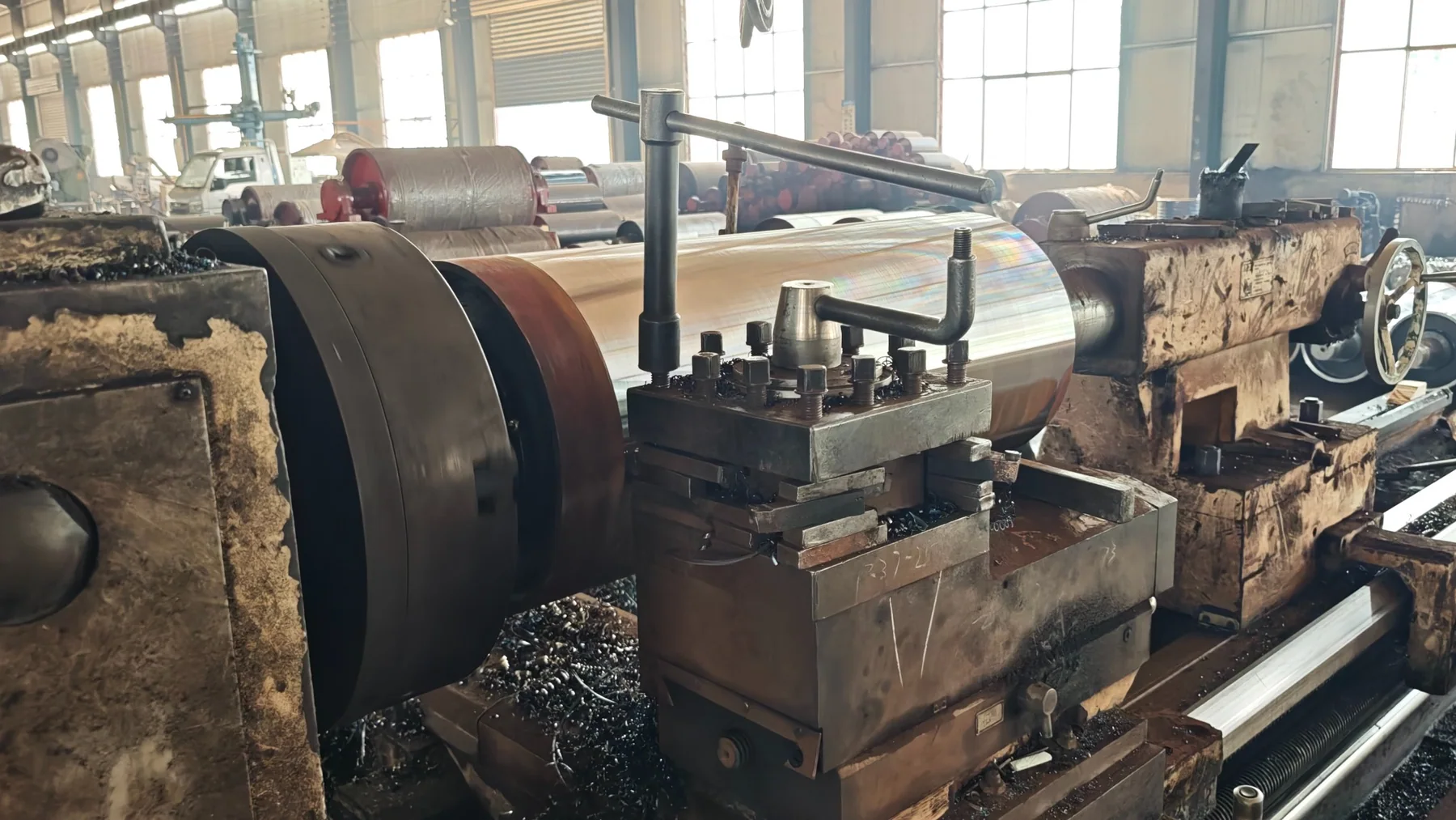 Conveyor pulley undergoing finish machining on a large lathe